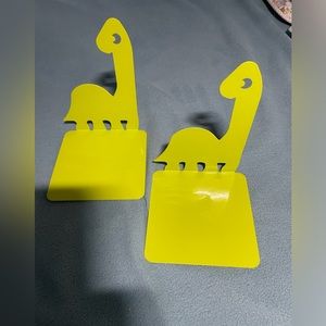 Set of bright green metal dinosaur book ends